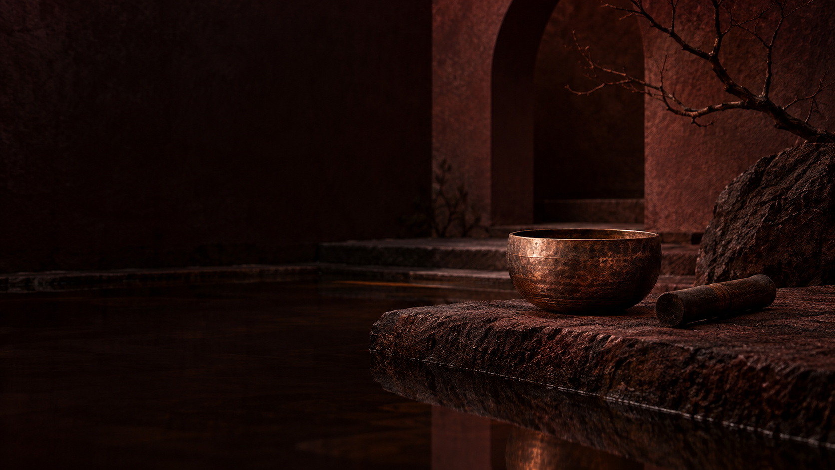 A singing bowl beside still water in a shadowy courtyard